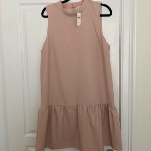Nude/very soft pink Anthropologie dress with a dropped hem.